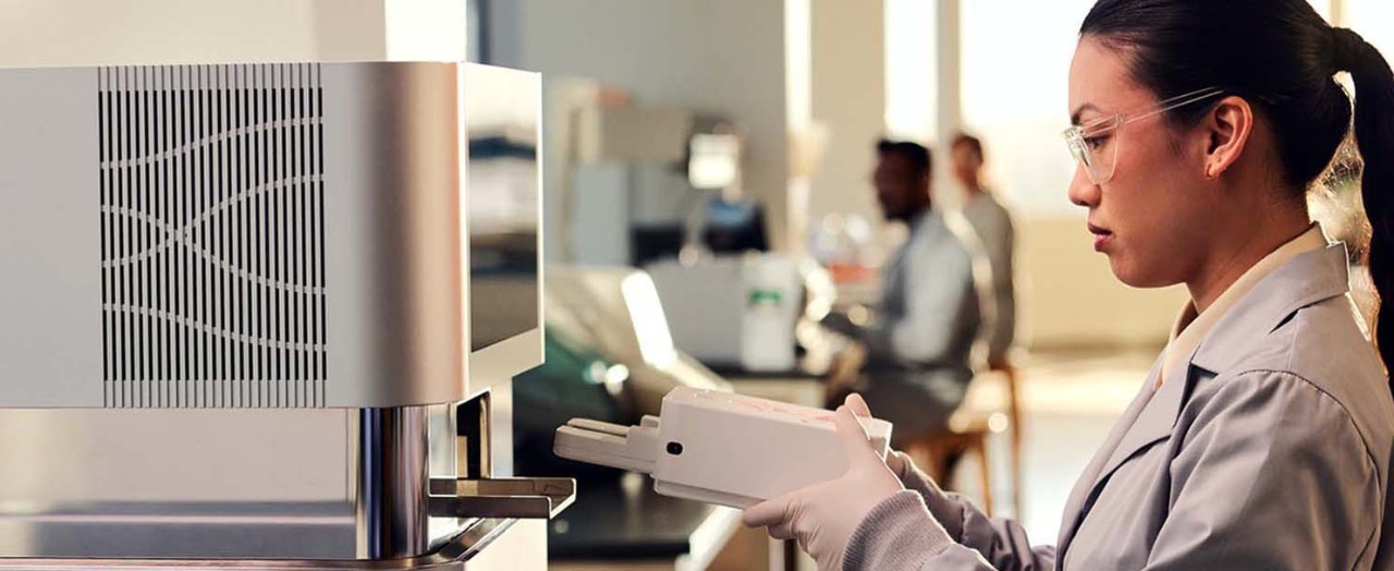 Researcher using genomics instrument